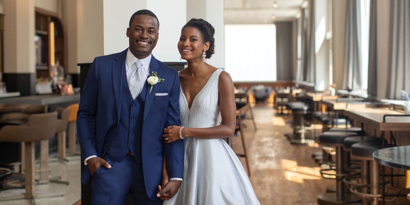 Сouple wearing a white gown and a blue suit